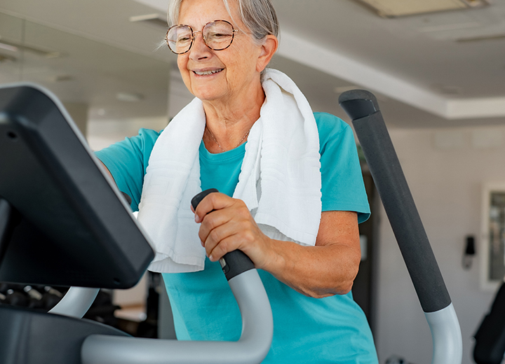Elderly woman working out at gym