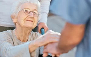 elderly woman hold nurse hands
